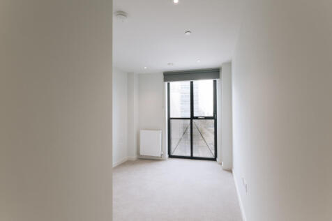 Experience tranquility in this spacious bedroom with a city view.