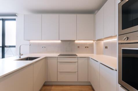 Explore the elegance of this modern kitchen, designed to merge style with functionality.