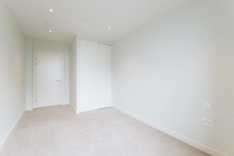 Explore this bright and airy bedroom, featuring modern design and ample closet space.