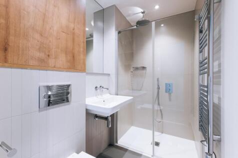 Experience the sophistication of this modern bathroom, complete with a luxurious glass shower.