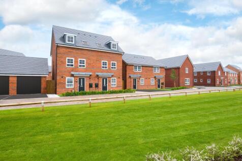 Street scene at pinewood park featuring three storey norbury homes and green open space to front asp