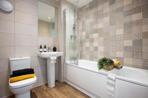 Family bathroom with full height tiling and shower over bath