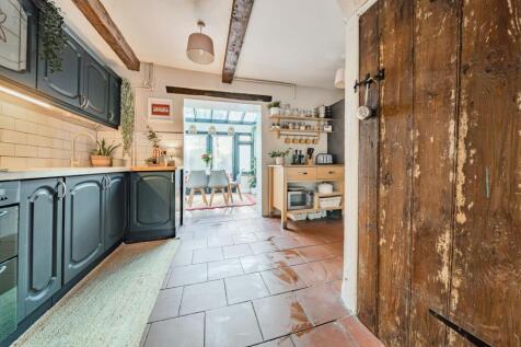 Kitchen with door leading into cellar