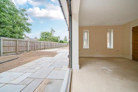 Living room with bi-folding doors out onto the patio area