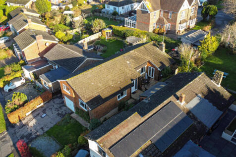 Elevated view showing front door and South facing side terrace