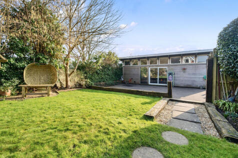 Rear garden, parking for four vehicles infront of outbuilding