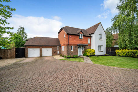 Front elevation with driveway providing parking for up to 5 vehicles