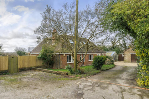 Front elevation with driveway providing parking for numerous vehicles