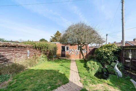 South facing private rear garden with direct access into the 19ft x 18ft detached double garage