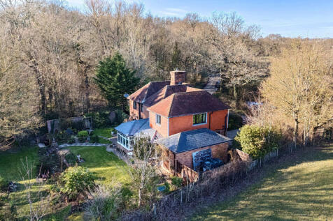 Side elevation, private and secluded south facing rear garden and private woodland overlooking open fields and woodland