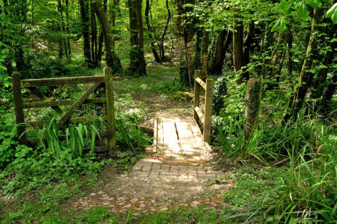 Quaint bridge over privately owned section of stream and into a portion of privately owned bluebell woods