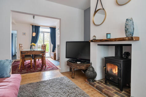 Living room open to the dining room with access directly onto the rear decking and garden