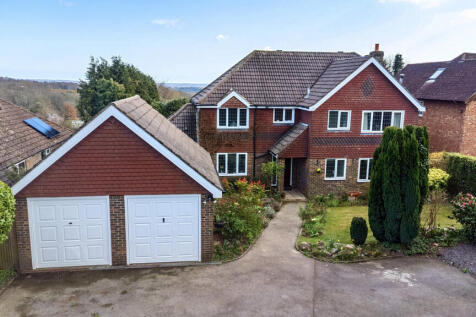 Front elevation, large detached double garage, and private parking for five to six vehicles
