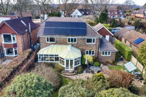 Elevated view showing the rear elevation, terrace and solar panels