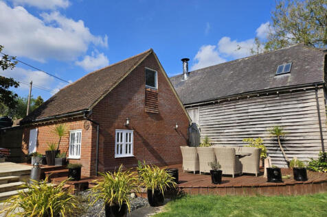 Detached double garage and large decking area at the rear