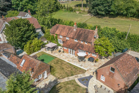 View over the house, garden, garage and outbuilding