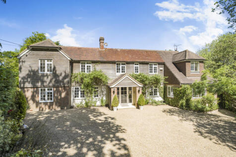 Front elevation and gated entrance to driveway providing parking for six vehicles comfortably