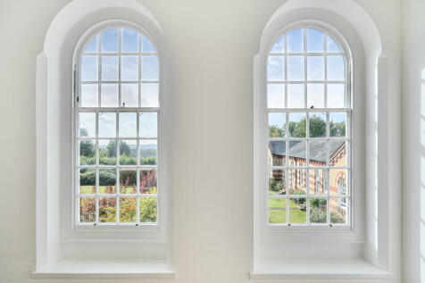 Operational sash windows with views over the communal grounds and The South Downs