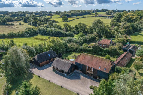 Elevated view over the property and outbuildings