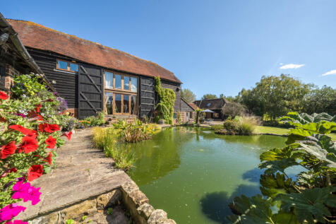 Old Brookhouse Barn and attractive pond in the rear garden