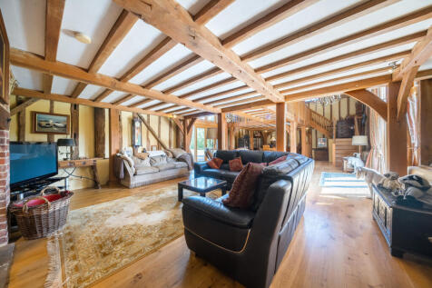 Large living area with fireplace and woodburning stove