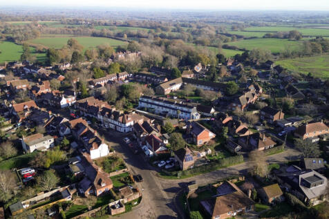 Aerial view over the house and open countryside and walks beyond