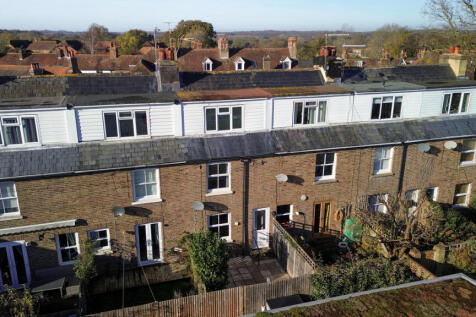 Elevated view over the house showing open countryside and walks beyond