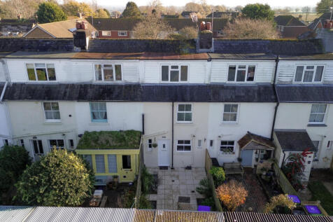 Elevated view over the house showing open countryside and walks beyond