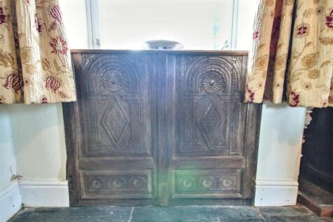 carved panel below dining room window