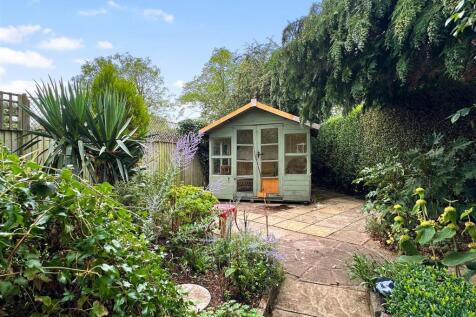 Secluded Garden With Extensive Paved Seating Area 
