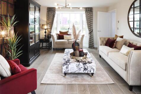 A lounge with bay window floods the room with light