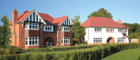 Two large detached houses with red tiled roofs, white and brick exteriors, set in a garden with tree