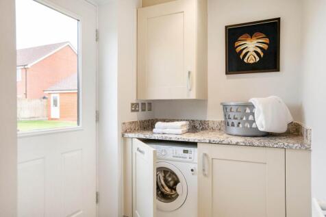 A utility area is perfect for laundry appliances and leads to the garden