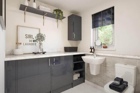 A guest cloakroom also hosts room for laundry appliances
