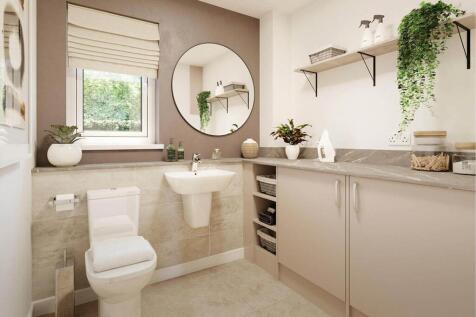 A guest cloakroom also hosts space for laundry appliances