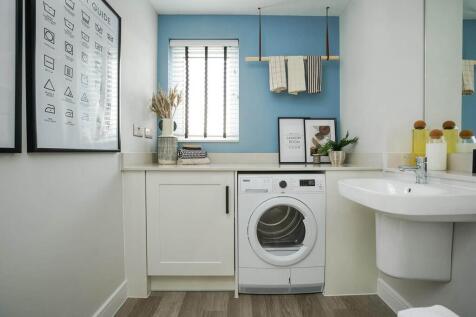 A guest cloakroom hosts space for laundry appliances