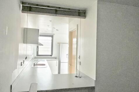 Bedroom through to kitchen area