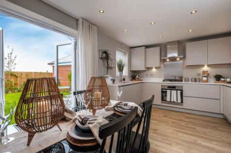 Internal photo of the Archford open plan kitchen diner, French doors open to the garden