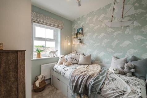 Single children&#39;s bedroom decorated with animal themed prints