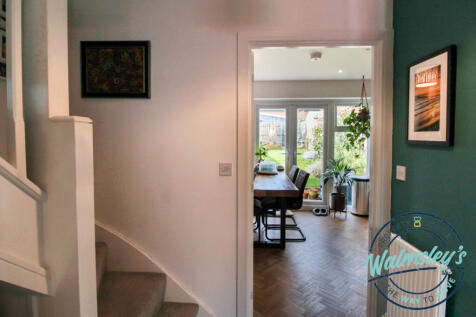 Staircase with kitchen beyond