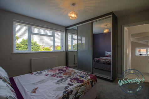 Bedroom three with hallway beyond