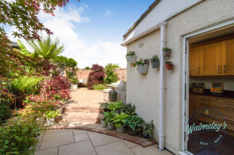 Landscaped gardens and access into kitchen