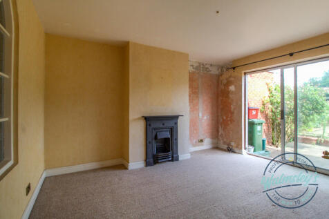 Rear sitting with fireplace and patio doors