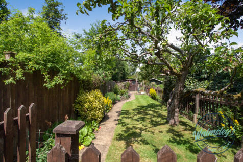 Gated rear gardens beyond entry