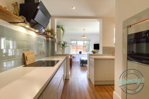 Stylish kitchen opening into garden room extension