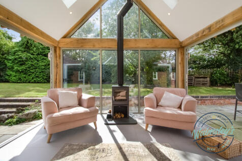 Log burner within wooden framed extension