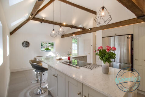 Kitchen with patio door open plan to family room