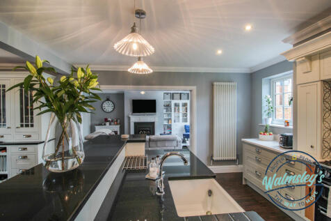 Open plan kitchen dining with family room beyond