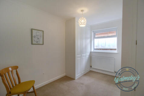Bedroom to side elevation with fitted wardrobes