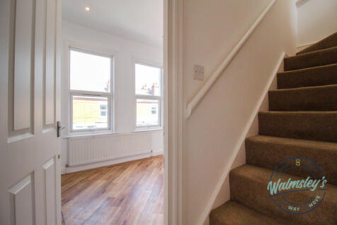 Staircase to top floor and front double bedroom